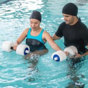 patient in aquatic therapy with physical therapist